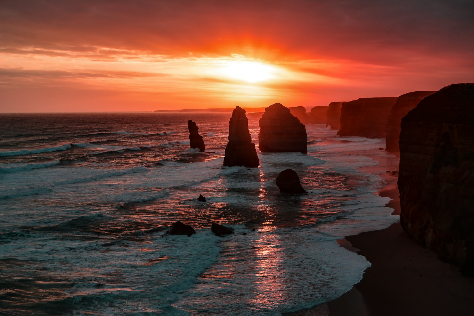Photo by Graham Holtshausen silhouette of stone on seashore during golden hour